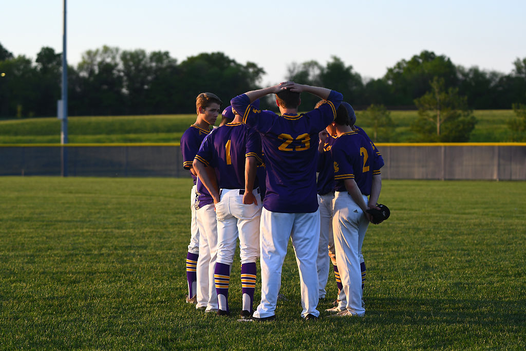 Seniors on the Hickman baseball team huddle in the outfield following a loss